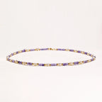Delicate 18K gold vermeil necklace with alternating lavender zirconia beads and white freshwater pearls on cream background