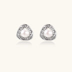 Triangular white gold plated stud earrings with central freshwater pearl and baguette-cut stones on white background