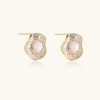 Gold-plated stud earrings with central freshwater pearl surrounded by radiating baguette crystals in sunburst design