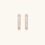 Gold pavé hoop earrings with two freshwater pearls nestled inside the curved design, featuring crystal-studded outer edge.