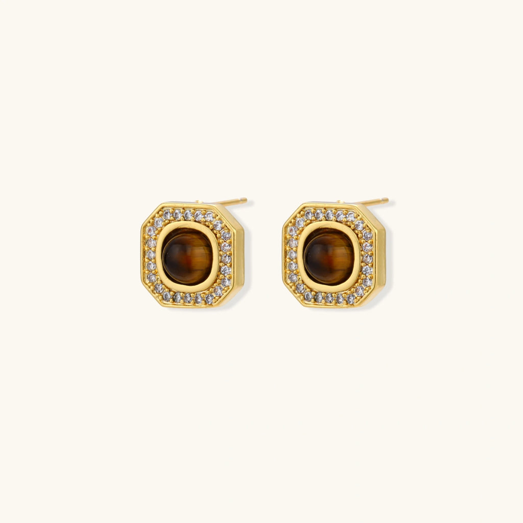 Gold-plated octagonal stud earrings with brown tiger's eye centers and cubic zirconia border on cream background.