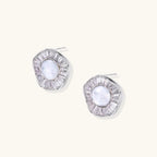White gold-plated stud earrings with iridescent pearl centers surrounded by baguette crystal halos on white background.