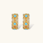 18K gold-plated hoop earrings with turquoise-centered flowers and crystal details on white background.