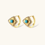 Close-up of 18K gold plated hoop earrings with turquoise center stones and zircon crystals in quatrefoil flower design
