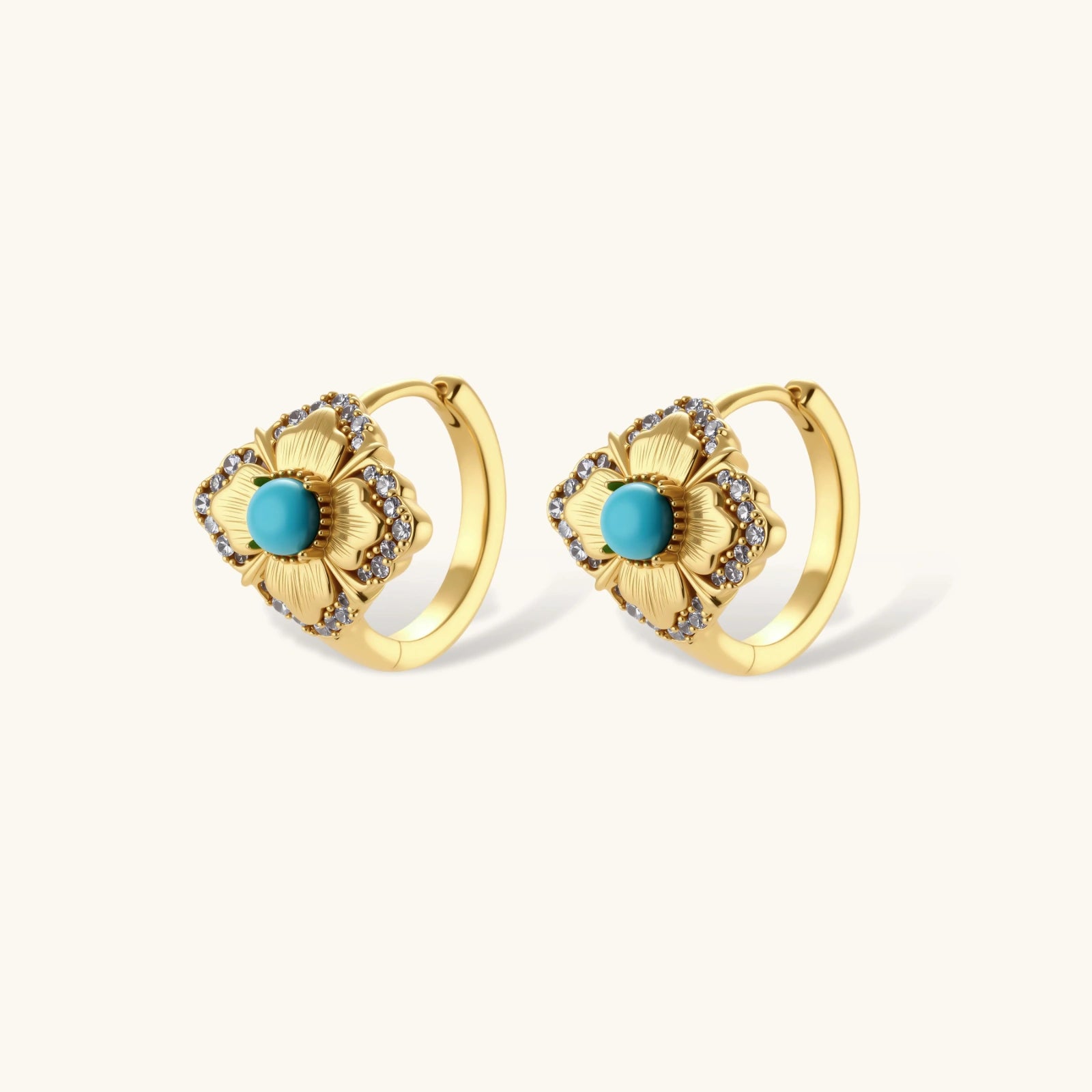 Close-up of 18K gold plated hoop earrings with turquoise center stones and zircon crystals in quatrefoil flower design