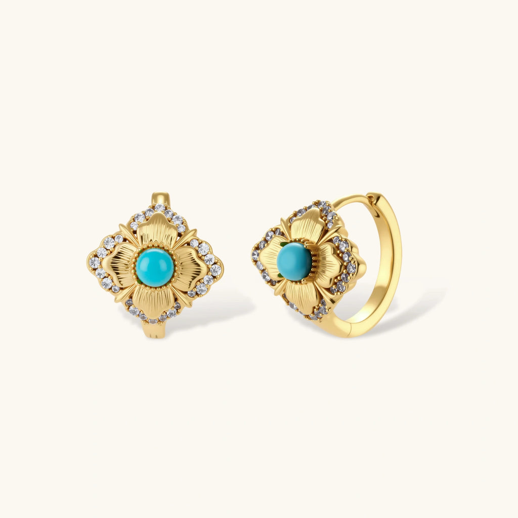 Close-up of 18K gold plated hoop earrings with turquoise center stones and zircon crystals in quatrefoil flower design