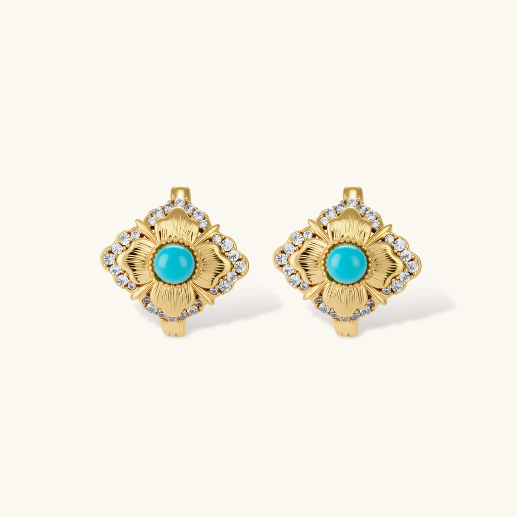 Close-up of 18K gold plated hoop earrings with turquoise center stones and zircon crystals in quatrefoil flower design
