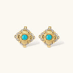 Close-up of 18K gold plated hoop earrings with turquoise center stones and zircon crystals in quatrefoil flower design