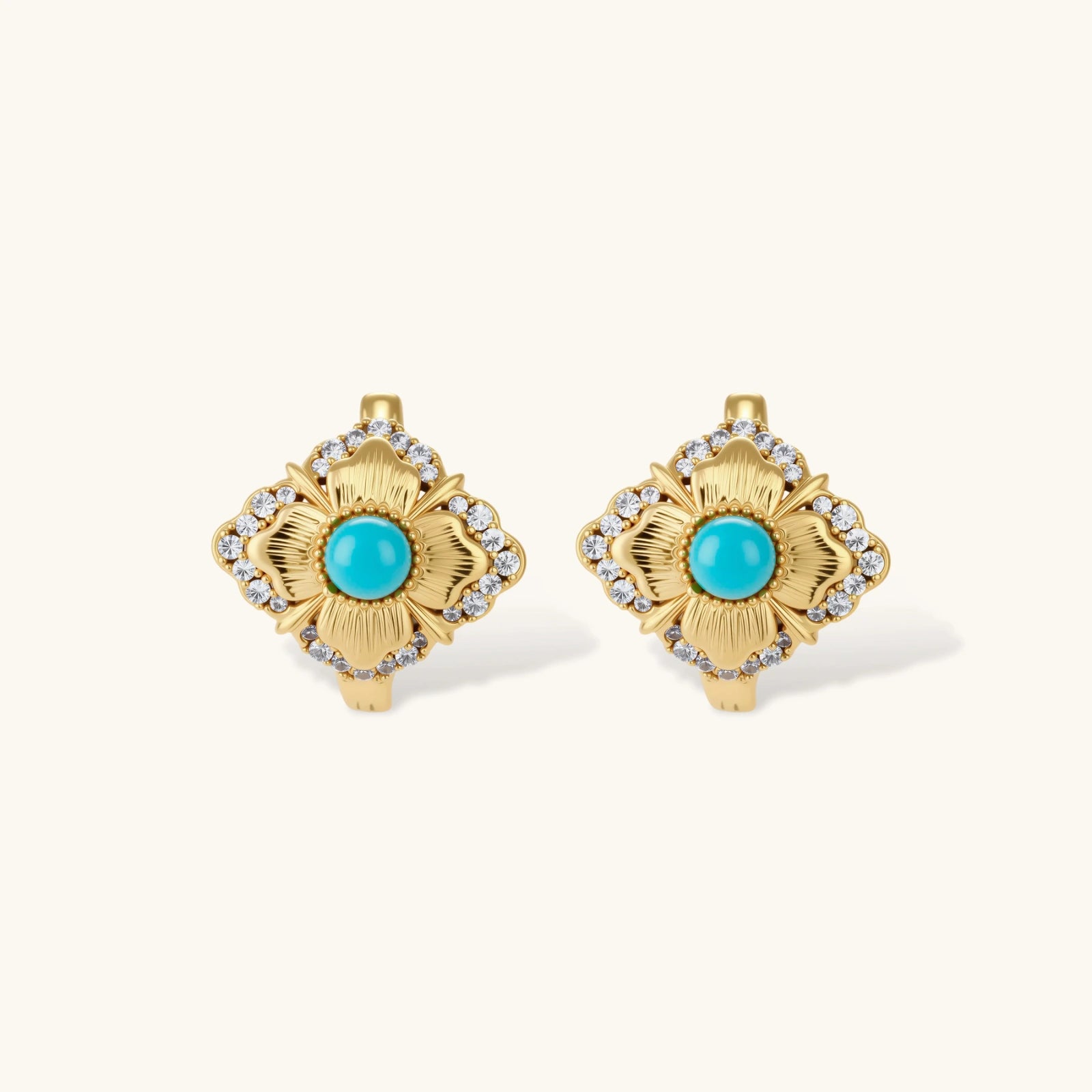 Close-up of 18K gold plated hoop earrings with turquoise center stones and zircon crystals in quatrefoil flower design