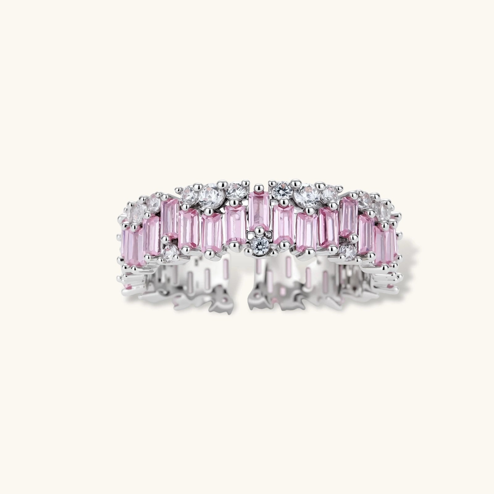 Adjustable eternity ring with alternating pink baguette and clear round cubic zirconia stones in palladium-plated setting