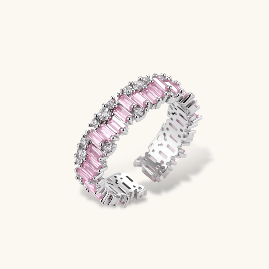 Adjustable eternity ring with alternating pink baguette and clear round cubic zirconia stones in palladium-plated setting