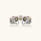 Adjustable copper ring with platinum plating, featuring alternating peach and green zirconia stones in organic wave pattern