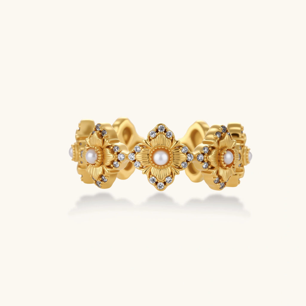 Gold-plated adjustable ring with multiple flower motifs, each featuring a central pearl and cubic zirconia stones