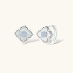 Silver-plated flower earrings with blue zirconia centers, featuring one stud and one huggie hoop in mismatched pair style.