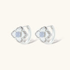 Silver-plated flower earrings with blue zirconia centers, featuring one stud and one huggie hoop in mismatched pair style.
