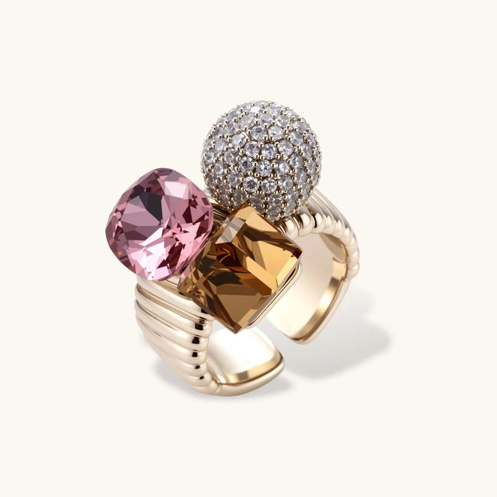 Bold adjustable ring featuring pink crystal, amber square stone, and crystal pavé sphere on coffee gold plated copper band.