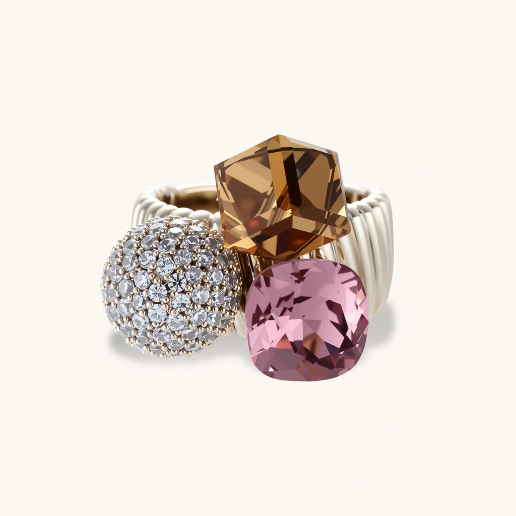 Bold adjustable ring featuring pink crystal, amber square stone, and crystal pavé sphere on coffee gold plated copper band.